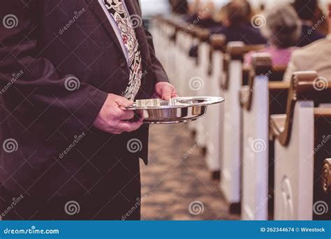 man passing  offering plate   traditional american church stock