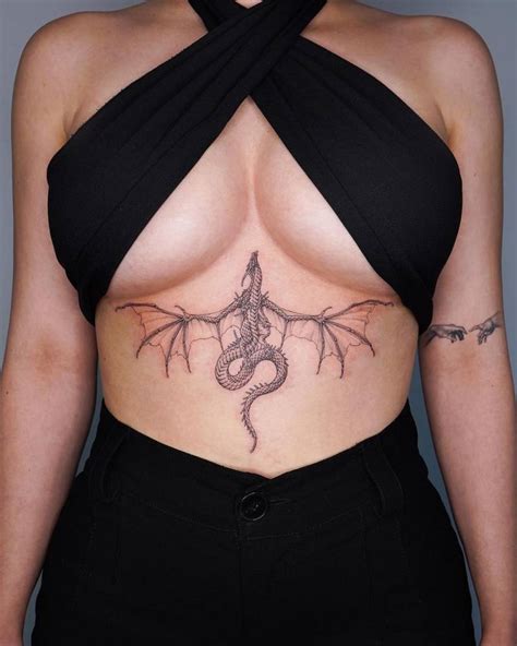 Dragon tattoo located on the stomach.