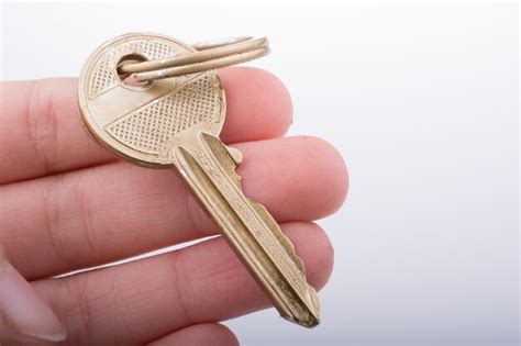 Premium Photo | Hand holding a golden color key