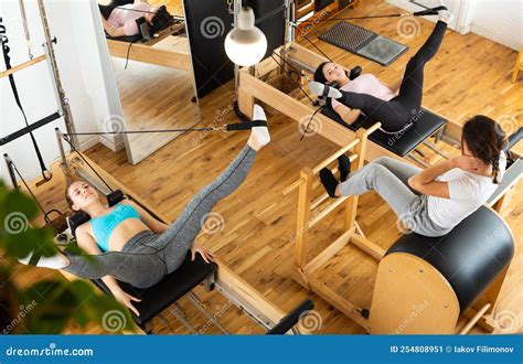 Young Women Practicing Pilates on Reformer at Gym Stock Image - Image ...