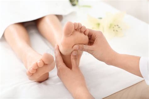 Young Woman Enjoying Foot Massage in Spa Salon, Focus on Legs Stock ...