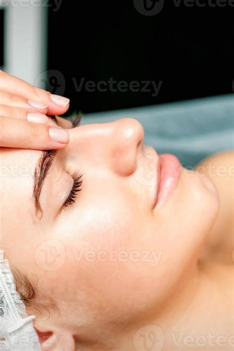 Female therapist making forehead massage 22429451 Stock Photo at Vecteezy