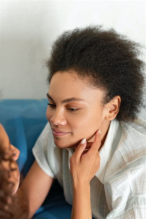 woman touching  persons face  stock photo