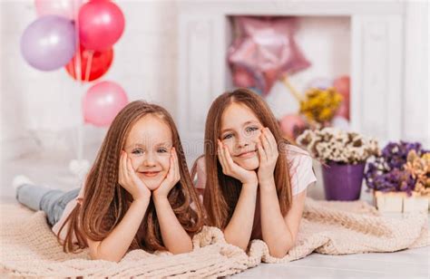 happy smiling teenage girls play   holiday room stock image