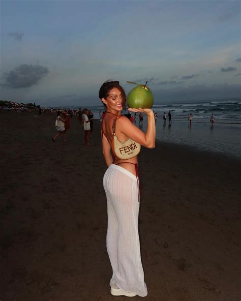 Rebekah Leah | Just a girl in her @tango_swim enjoying a coconut by the