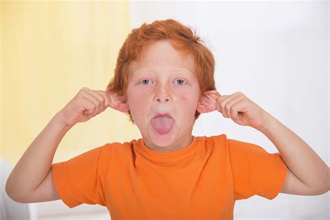 Portrait Of Boy Pulling A Rude Face Photograph by Lea Paterson/science ...
