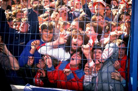 People being crushed against a fence during a human crush at ...