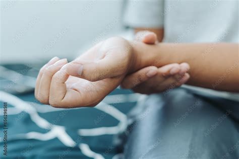 asian indonesian man holding  touching  wrist caused  injury