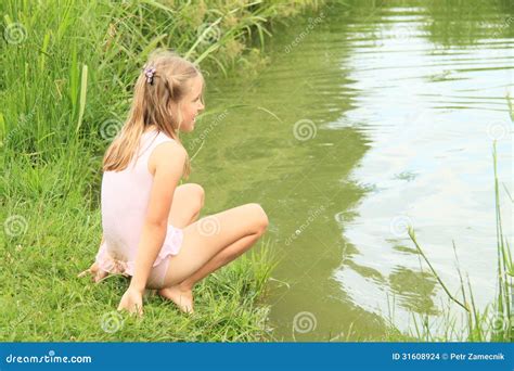Little Girl Watching Water in Pond Stock Photo - Image of child, grass ...
