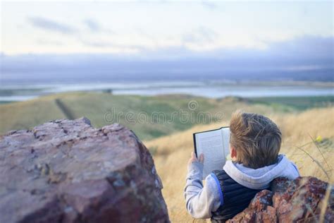 Boy reading book outside stock image. Image of outside - 104589673