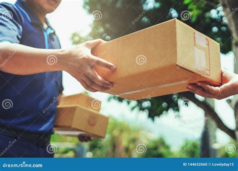 delivery man delivering holding parcel box stock photography
