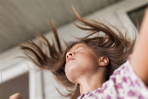 pretty young girl flipping hair  stocksy contributor amanda