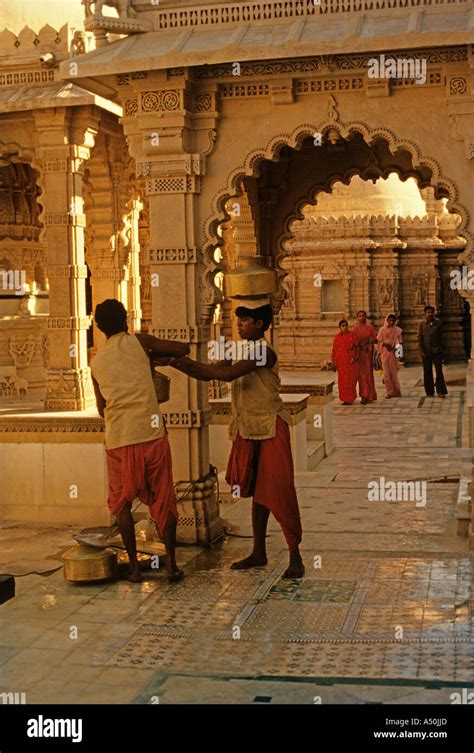 Man working at Jain temple Stock Photo - Alamy