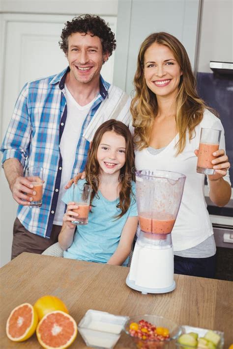 Portrait of Smiling Family with Fruit Juice Stock Image - Image of ...