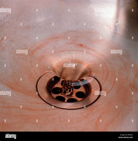 Red water flowing down a drain Stock Photo - Alamy