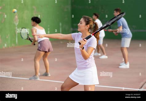 woman playing frontenis  partners  sunny day healthy lifestyle