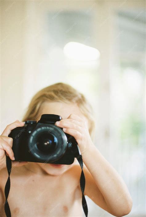 Premium Photo | Young nude girl taking a picture with a camera