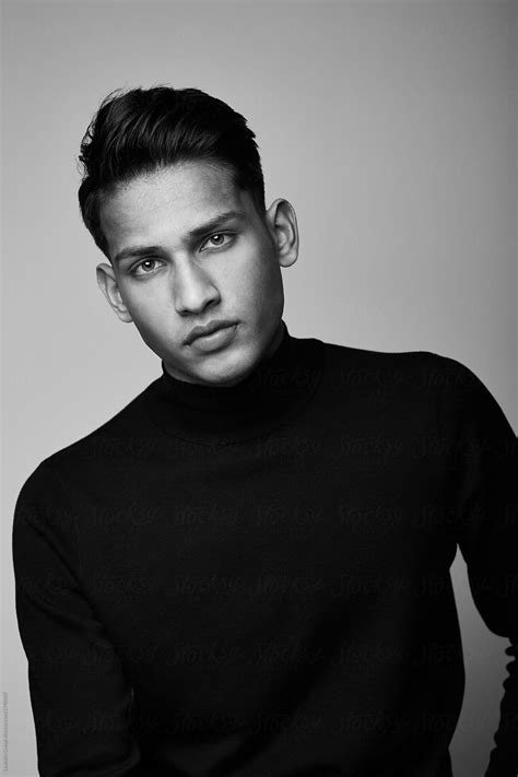 "Handsome Indian Guy Portrait Wearing Turtle Neck Isolated On Black And