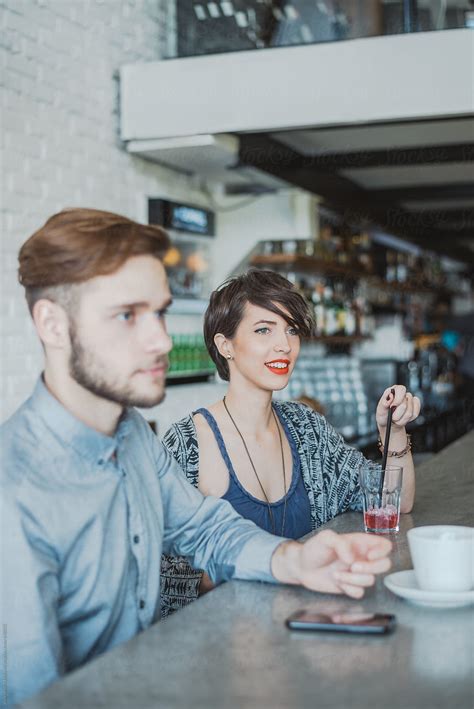 "Young Man And Woman Having A Drink At The Cafe" by Stocksy Contributor