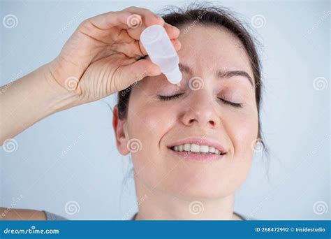 Caucasian Woman Dripping Moisturizing Drops into Her Eyes. Stock Photo ...