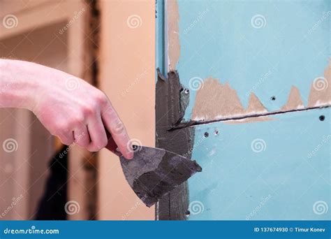 Closeup Builder's Hand Smears Cement Glue On The Wall With Trowel To ...