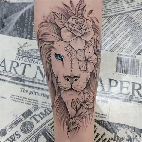 a tattoo with a lion and flowers on it