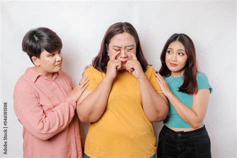 A portrait of three friends looking sad crying wiped her tears and hug ...