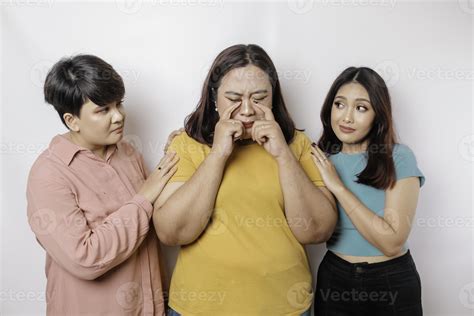 A portrait of three friends looking sad crying wiped her tears and hug ...