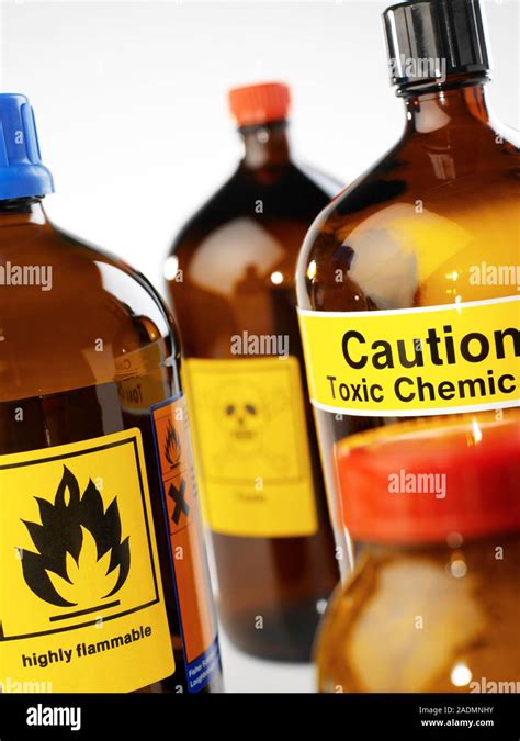 Hazardous chemicals. Containers labelled with chemical hazard warning ...