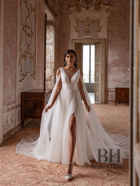Wedding dress with open draped corset and detachable wings, skirt with