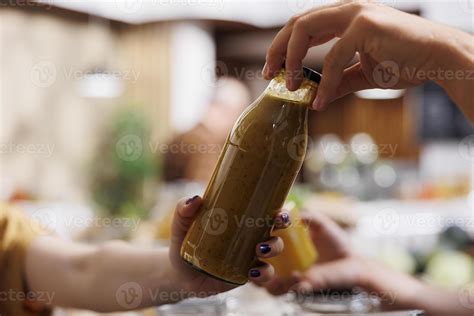 Storekeeper offering woman shopping in zero waste grocery store organic