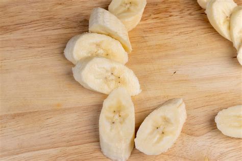 Premium Photo | A ripe sweet banana cut into pieces lies on the table