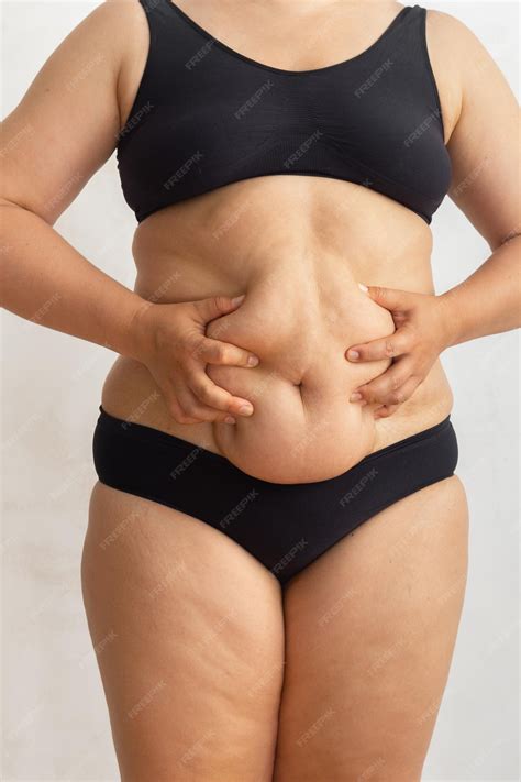 Premium Photo | Cropped overweight fat woman in black bikini touching
