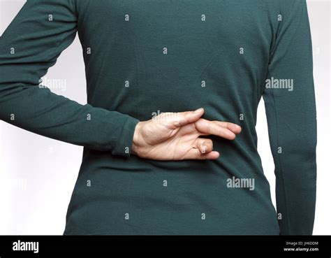 Crossed fingers behind back hi-res stock photography and images - Alamy