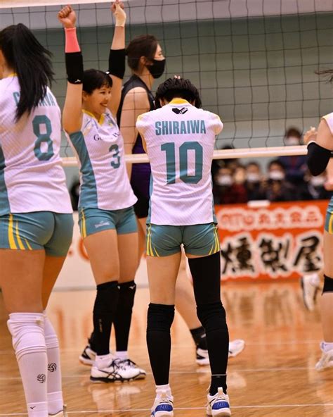 the girls are playing volleyball on the court and ready to hit the ball ...