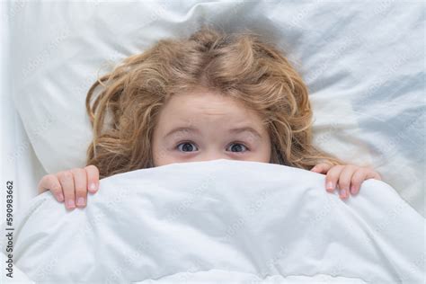 Nightmare kids, child hiding under white blanket, top view. Scared boy ...