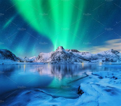 Aurora borealis over snowy mountains containing aurora, northern lights