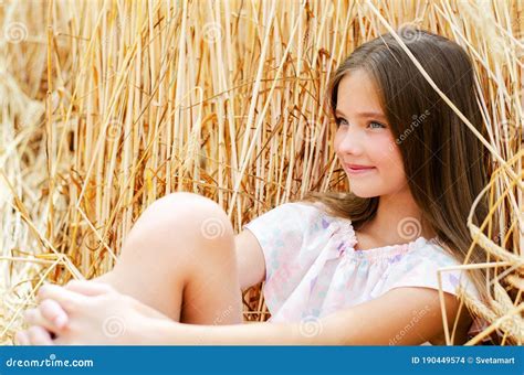 Portrait of Smiling Cute Little Girl Child Sitting on Field of Wheat ...