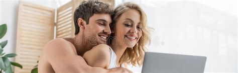 shirtless man hugging blonde girlfriend stock   royalty
