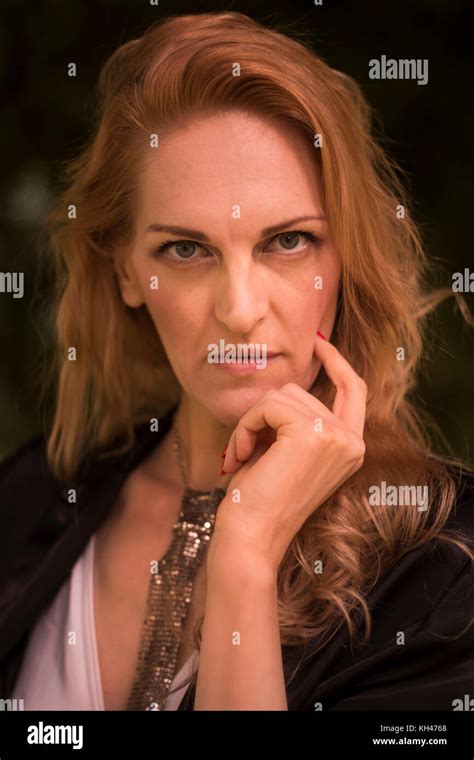 one mature Caucasian beautiful woman, late 40s, outdoors portrait head ...