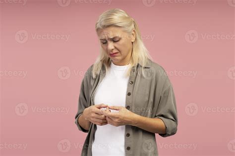Sad woman touching wedding ring experiencing loneliness and heartbreak