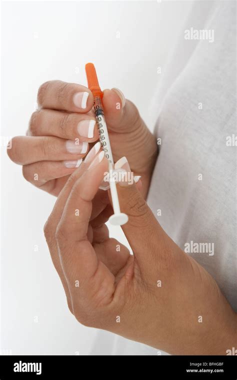 close  hand holding syringe  res stock photography  images alamy