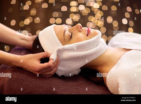 woman having face massage with towel at spa Stock Photo - Alamy