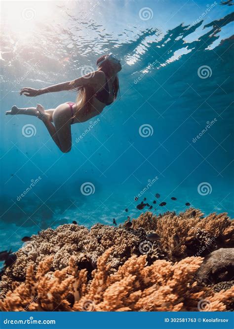 Woman Swims Underwater in Tropical Sea. Snorkeling in Hawaii Stock