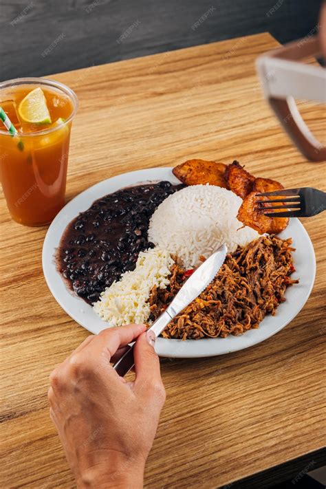 Premium Photo | Girl eating a plate of venezuelan food pabellon criollo
