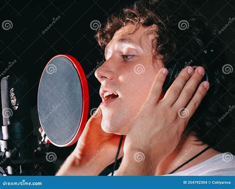 Male Vocal Artist with Curly Hair Singing Alone. Young Handsome Singer