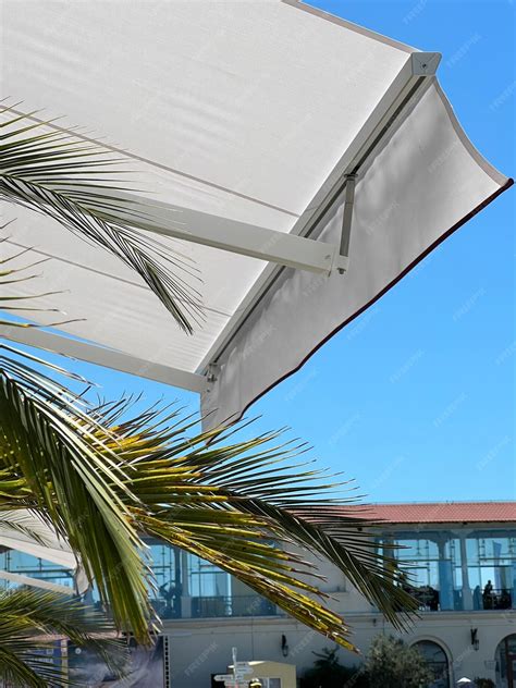 Premium Photo | White fabric awning with the palm leaves white sunshade