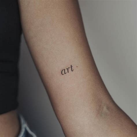 Word "art" tattooed on the inner forearm.