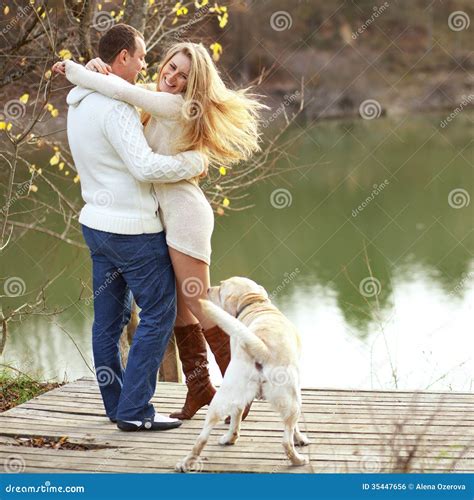 Couple with dog stock photo. Image of happy, autumn, married - 35447656