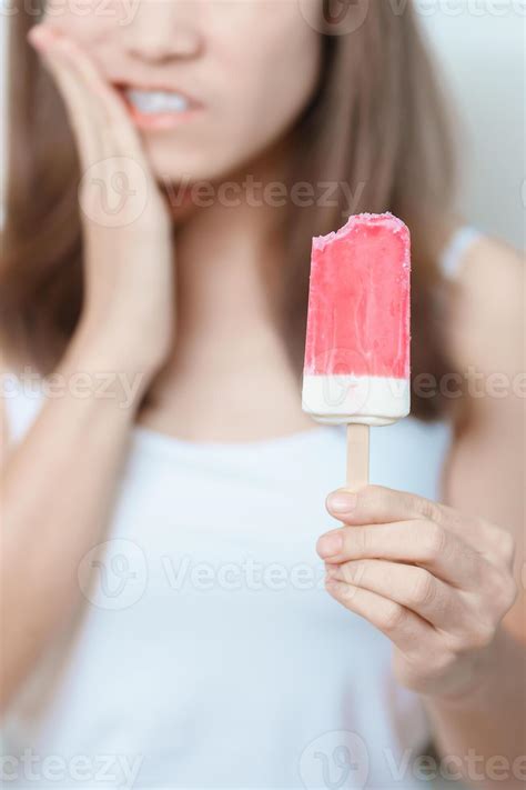 Teeth Sensitive to Cold concept. woman hold Ice cream and having